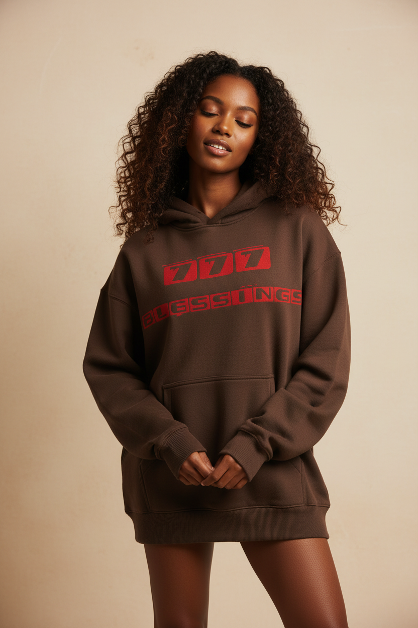 Black woman wearing 777 Blessings brown hoodie